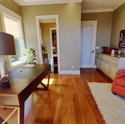 an empty living room with a desk and a couch at Stunning view in elegant 1 bedroom suite in West Vancouver