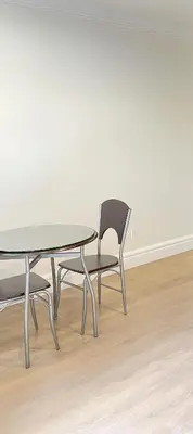 a table and a chair sitting next to a table at Beautiful place with Kitchen, Washing Machine, Internet near UBC, beach and DT in Vancouver