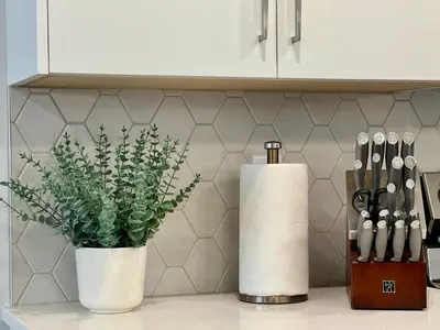 a kitchen counter with two white vases and a plant at Mountain View New Luxury Condo at Banff Entrance in Canmore