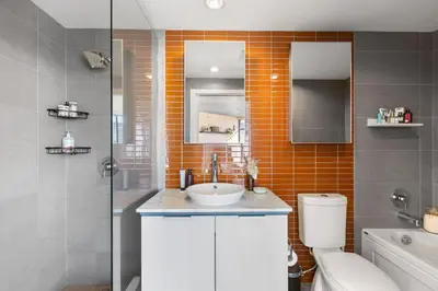 a bathroom with a sink and a toilet at Luxury Central Apartment with City Views in Vancouver