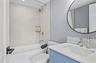 a white bathroom with a sink and a mirror at Charming 2BR Haven in Canmore Near DT and Banff in Canmore