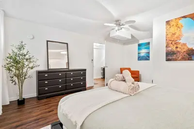 a bedroom with a bed with a dresser and a mirror at 1 Bedroom Cozy Retreat - Queen Bed, Pet Friendly, Smart TV, Secure & Private Access, Free Parking, Netflix & More! in Calgary