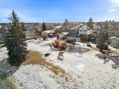 an aerial view of a park with a playground at 1 Bedroom Cozy Retreat - Queen Bed, Pet Friendly, Smart TV, Secure & Private Access, Free Parking, Netflix & More! in Calgary