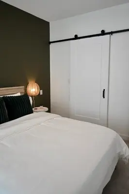 a bedroom with a large white bed with a large sliding door at Stylish 2-Bedroom Condo - Premium Comfort, Central Location in Surrey