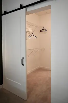 an open door in a room with a closet at Stylish 2-Bedroom Condo - Premium Comfort, Central Location in Surrey