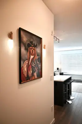 a painting of a dog hanging on a wall at Stylish 2-Bedroom Condo - Premium Comfort, Central Location in Surrey