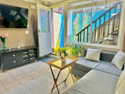 a living room with a couch and a table at Lovely 2BR BSMT Suite w Parking for Pickup in North Vancouver