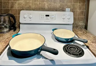 two pots sitting on top of a stove at Lovely 2BR BSMT Suite w Parking for Pickup in North Vancouver