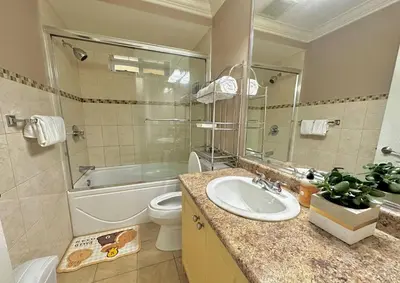 a bathroom with a sink and a toilet and a tub at Lovely 2BR BSMT Suite w Parking for Pickup in North Vancouver