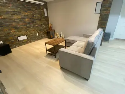 a living room with a couch and a table at Francis' Home Stay in Calgary