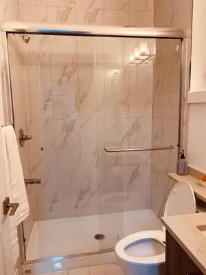 a bathroom with a shower with a toilet at Sweet home 2 bedroom suite in Surrey