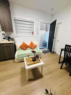 a living room with a couch and a table at Sweet home 2 bedroom suite in Surrey
