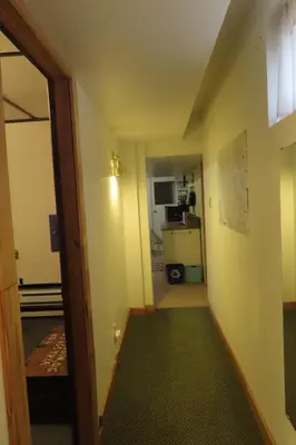 a room with a hallway with a kitchen and a door at Friendly Footprint in Golden