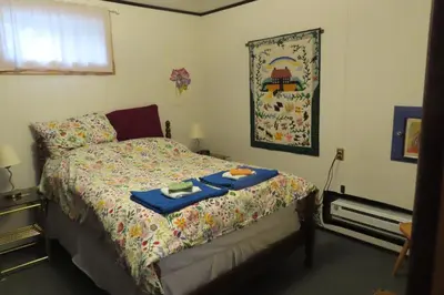 a bedroom with a bed with a tray of food on it at Friendly Footprint in Golden
