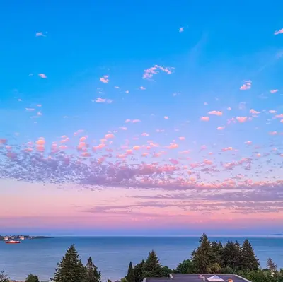a view of the ocean at sunset with clouds at HOV B&B House -Hospitality Ocean View Victoria- in Victoria