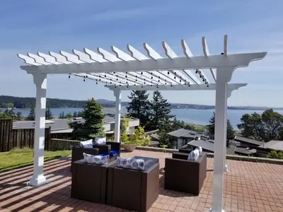 a white pergola with chairs and tables on a patio at HOV B&B House -Hospitality Ocean View Victoria- in Victoria