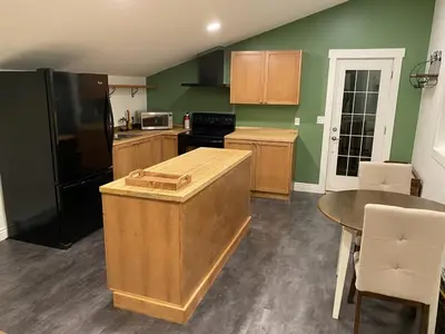 a kitchen with a black refrigerator and a table at Bluebird Nest in Golden