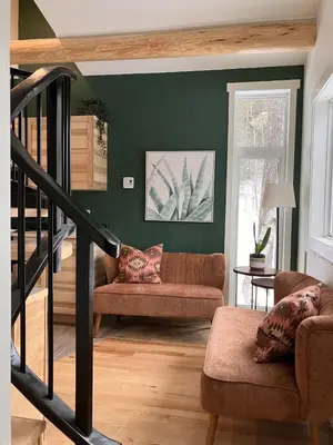 a living room with a couch and a staircase at Alder House in Golden