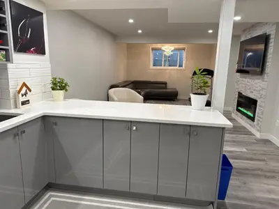 a kitchen with a large island in a living room at HansBnB near Airport in Calgary