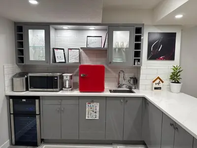 a kitchen with a red refrigerator on a counter at HansBnB near Airport in Calgary