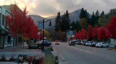 a town street with cars parked on the side of the road at Sparkling NEW Rossland Midtown Studio Apartment in Rossland