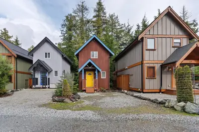 a row of houses with a driveway at Tyee Retreat Cozy Lofted 1 Bedroom Cabin in Ucluelet