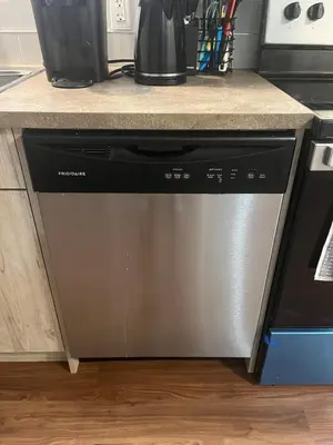 a dishwasher under a counter in a kitchen at Cozy Basement Near Airport YYC in Calgary