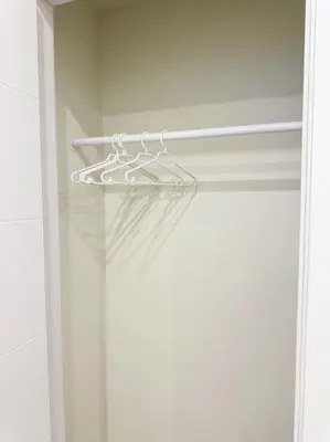 a glass shower door with a hanger in a bathroom at Cozy Guest Suite Near University of Alberta, Southgate Mall, and Downtown in Edmonton
