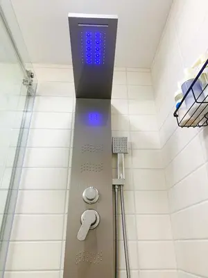 a shower with a blue light in a bathroom at Cozy Guest Suite Near University of Alberta, Southgate Mall, and Downtown in Edmonton