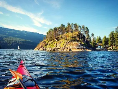 a person in a kayak on a body of water at North Vancouver Retreat, Cozy & Central, Walk to Lonsdale & Seabus in North Vancouver