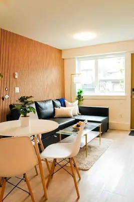 a living room with a couch and a table at North Vancouver Retreat, Cozy & Central, Walk to Lonsdale & Seabus in North Vancouver