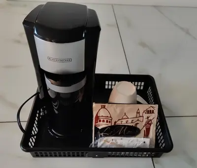 a black and white coffee maker in a basket at D Peaceful Suite in West Vancouver
