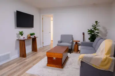 a living room with two chairs and a tv at The Vida 1 Bed Pet-Friendly in Abbotsford