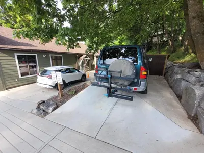a van parked in a driveway with a tent in the back at Fresh Studio Apartment in Central Rossland in Rossland