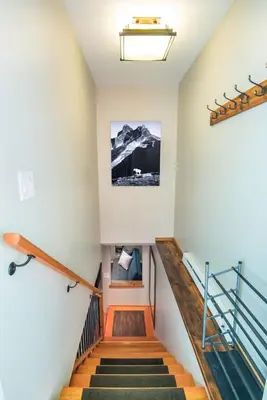 a set of stairs in a house with a stair case at Fresh Studio Apartment in Central Rossland in Rossland