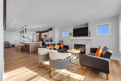 a living room with a couch and a fireplace at Your Pleasant stay in 3 bedroom House in Saddle-Ridge in Calgary