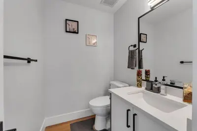 a white bathroom with a toilet and a sink at Your Pleasant stay in 3 bedroom House in Saddle-Ridge in Calgary