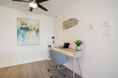 an office with a desk and a chair and a ceiling fan at Yaletown Gorgeous Unit Steps from the Beach in Vancouver