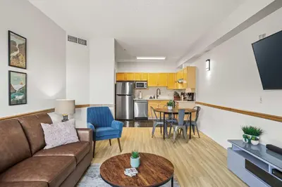 a living room with a couch and a table at Charming & Cozy 1-Bedroom Retreat in Canmore
