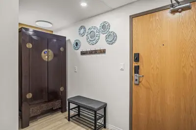 a room with a stool next to a door at Charming & Cozy 1-Bedroom Retreat in Canmore