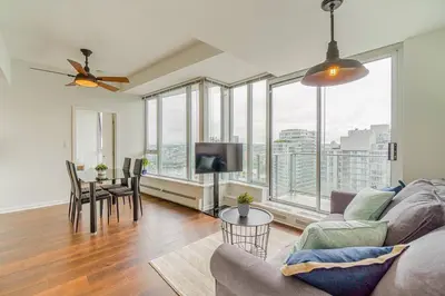 a living room with a couch and a table at Home in the Sky with Gorgeous Water Views in Vancouver
