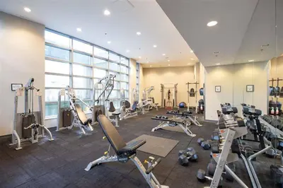 a gym with treadmills and machines in a room at Home in the Sky with Gorgeous Water Views in Vancouver