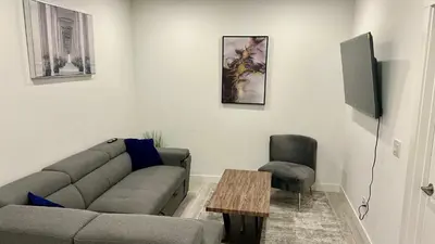 a living room with a couch and a table at Private Very Spacious 2 bed 1-Bedroom basement Suite SW Calgary in Calgary