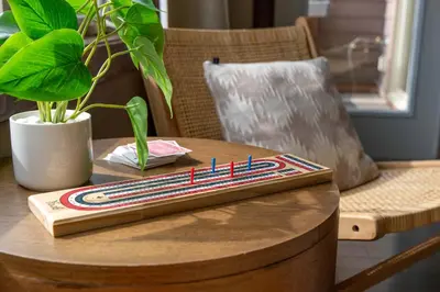 a wooden table with a book on top of it at Breathtaking Luxury 3Bd Penthouse Pool and Hot Tub in Canmore