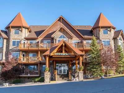 a large apartment building with a gambrel roof at Breathtaking Luxury 3Bd Penthouse Pool and Hot Tub in Canmore