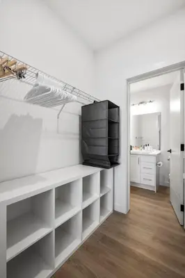 a living room with a tv on a shelf at Luxury Aspen 2BR Home with Double Garage Car Parking in Calgary