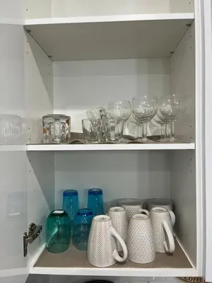 a cupboard filled with lots of glasses and vases at Elegant 3BD Home in Beaumont, Double Garage in Nisku