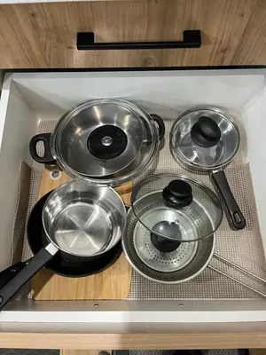 a group of pots and pans sitting on top of a stove at Elegant 3BD Home in Beaumont, Double Garage in Nisku