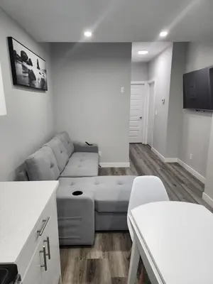 a living room with a couch and a table at lovely 2bed & 1 Bath Basement Suite for 4 guests in Calgary