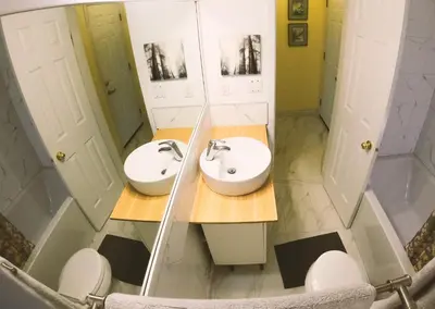 a bathroom with two sinks and a mirror at Calm, cozy, urban, family-friendly stay in Vancouver